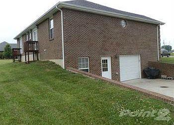 Access to lower level from inside and outside by large concrete patio