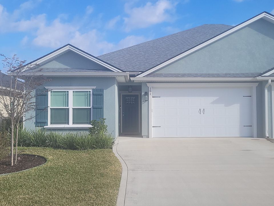 Front of unit with 2 car garage and professional landscape and rubber mulch. No yard work