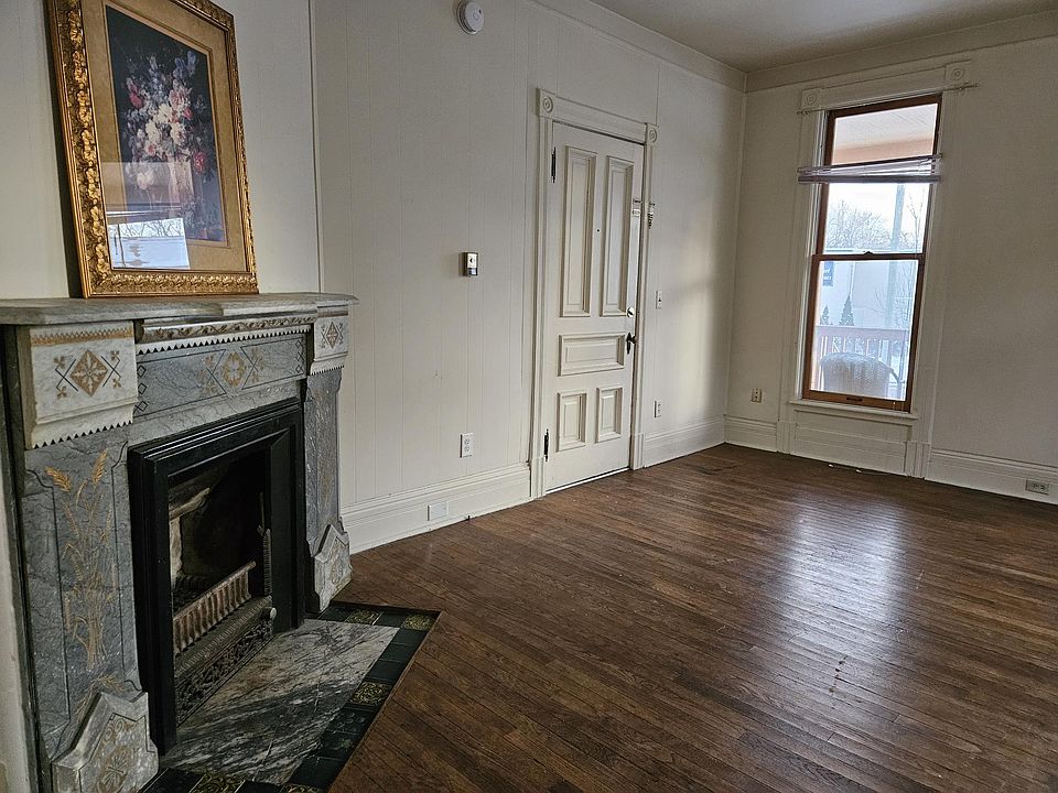 Lvgrm shows door to public hall; decorative fireplace