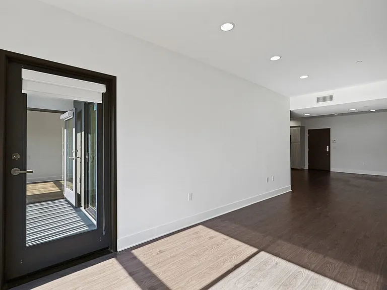 Open-Concept Kitchen, Dining, and Living Room Areas with Patio