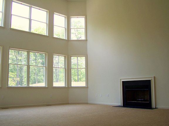 The sunken family room offers a gas fireplace and is two stories.
