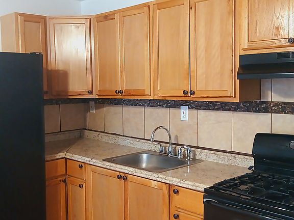 Newly renovated kitchen with beautifully stained cabinets and new hardward