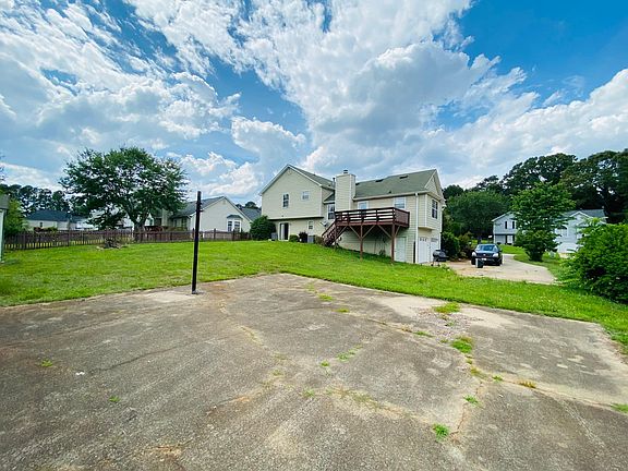 Big backyard with paved basketball court.