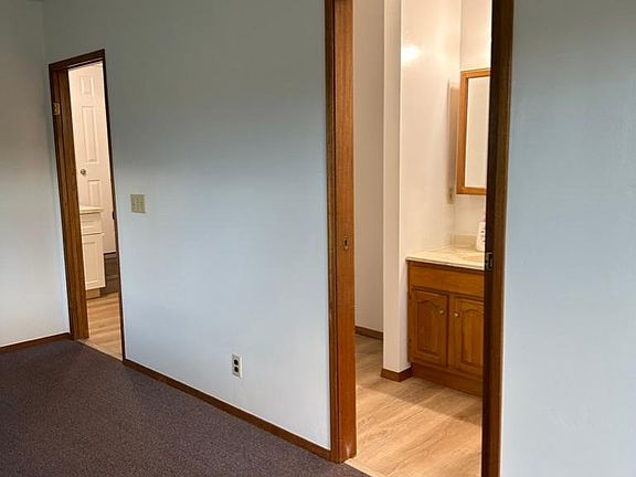 View from bedroom into kitchen and bathroom.