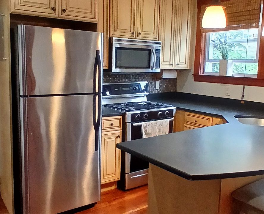 Kitchen island, honed granite, cherrywood floors. Stainless appliances.