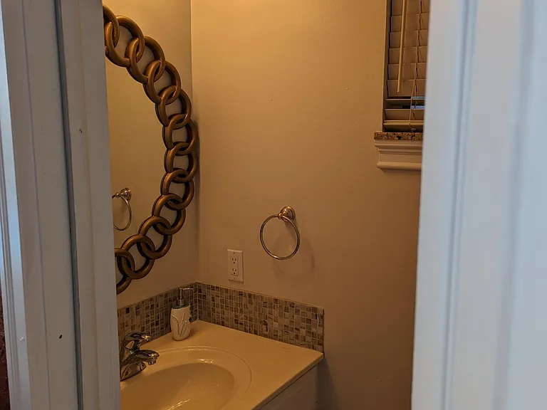 Poolside half-bath sink/mirror.