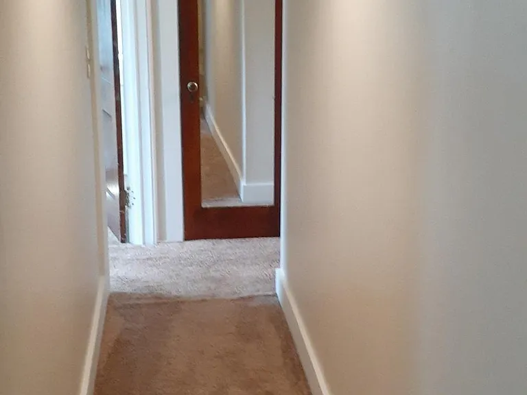 Hallway leading to bedrooms, bathroom and closet at the end of the hall