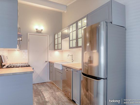 Hardwood flooring and wood-topped counters add a warm touch to this Scandinavian-inspired, eat-in kitchen