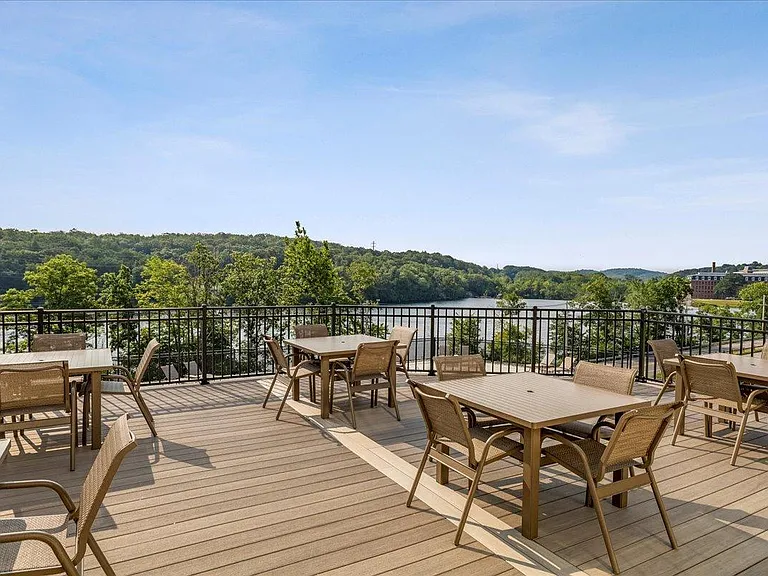 River view deck with tables and seating.