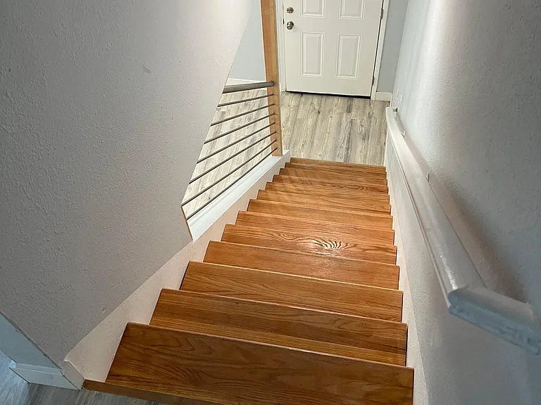 Beautiful stairway with wood rail and stainless banister