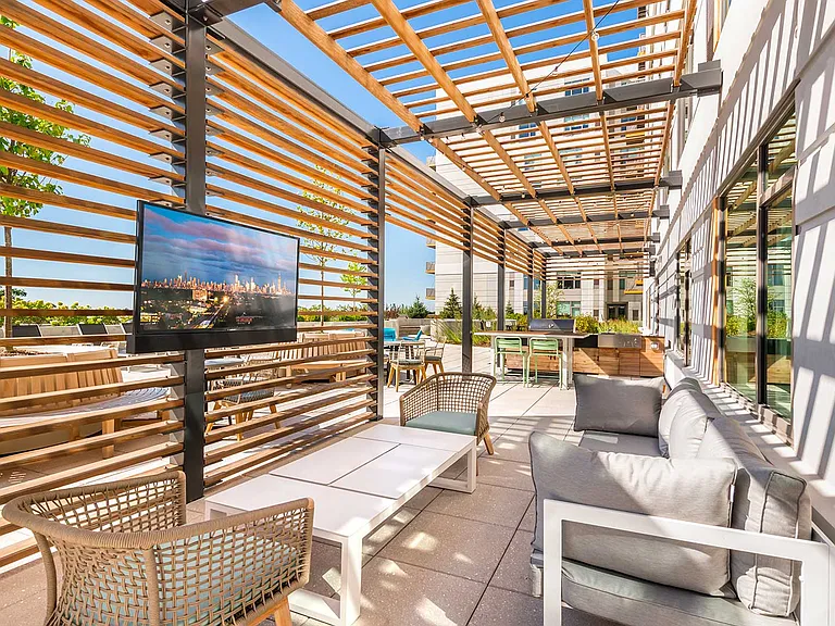 Eleven33's outdoor lounge brings people together with comfortable seating, shaded spaces, and an outdoor TV ideal for game nights or laid-back evenings in Oak Park.