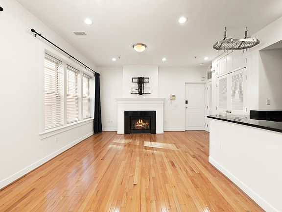 Sun-filled top-floor living with skylight, hardwoods, high ceilings, and gas fireplace