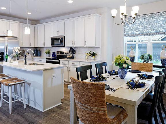 The kitchen and dining area of the Picasso III by Brookfield Residential