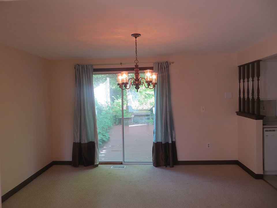 Dining area overlooks private backyard with deck