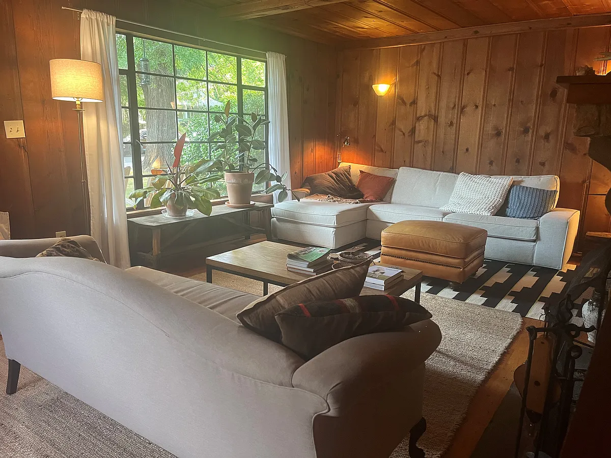 Living room with wall sconces, built-in bookshelf, picture window, and working fireplace. - 408 Pritchard Ave