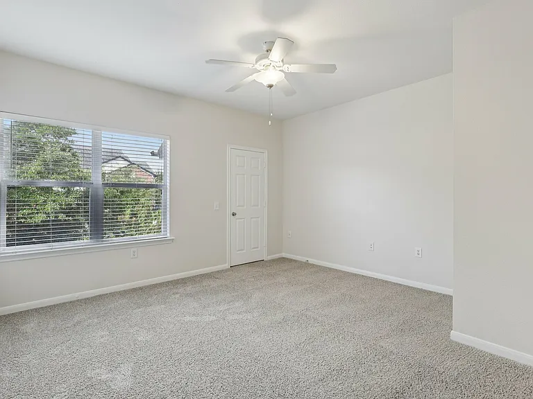 Bright and spacious bedroom with plush carpeting and large window offering scenic views. Bright and spacious bedroom with plush carpeting and large window offering scenic views.