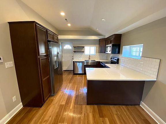 Kitchen area. There is a counter top overhang to accommodate multiple bar stools.