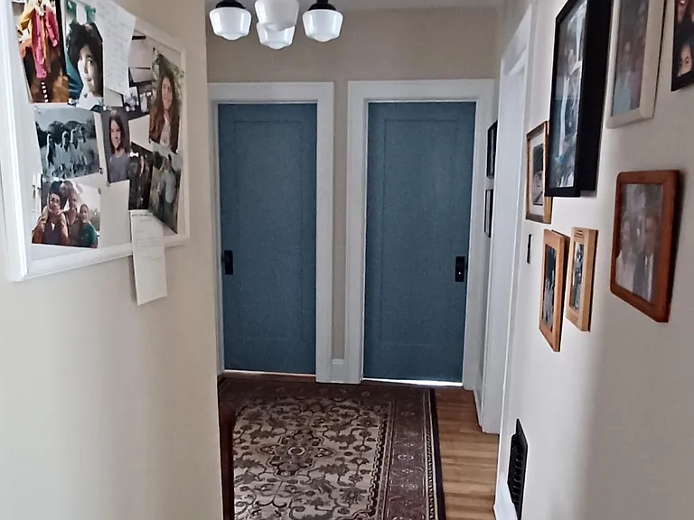 Enter well-lit hallway from dining room, leading to bedrooms and bathroom.