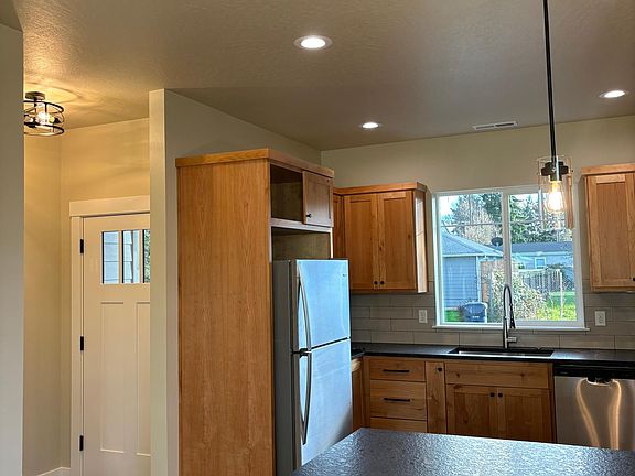 Entry with coat closet and kitchen