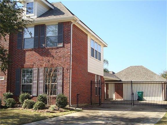 Detached garage with a wrought iron gate.