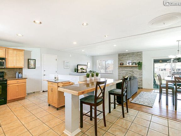 View of kitchen, bar, seating area, and great room