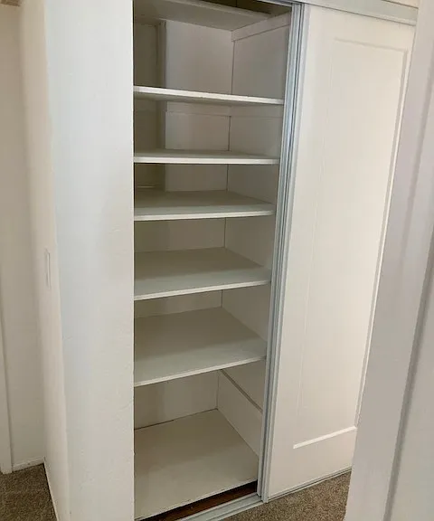 Hall closet (half has shelving, the other half has no shelving)