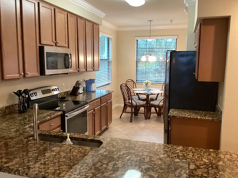 Granite kitchen with breakfast nook seating for 4
