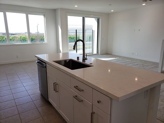 Kitchen opens to Dining Room and Living Room