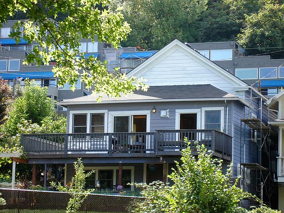 Back view of house. Lower unit below deck. Overlooks the garden
