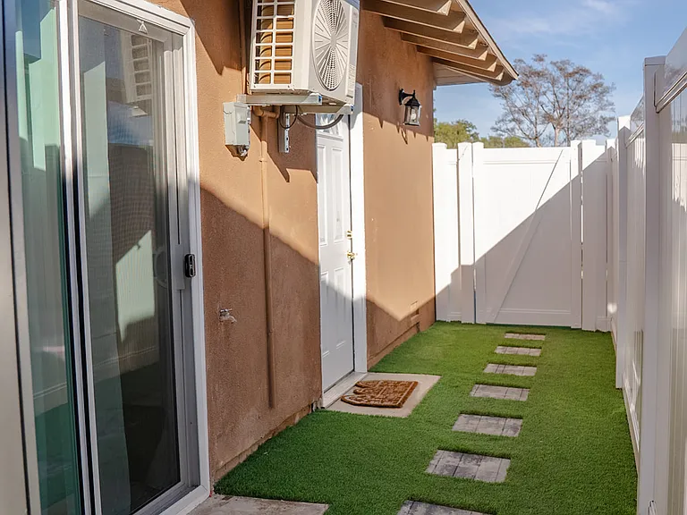 Private entrance and turfed side yard