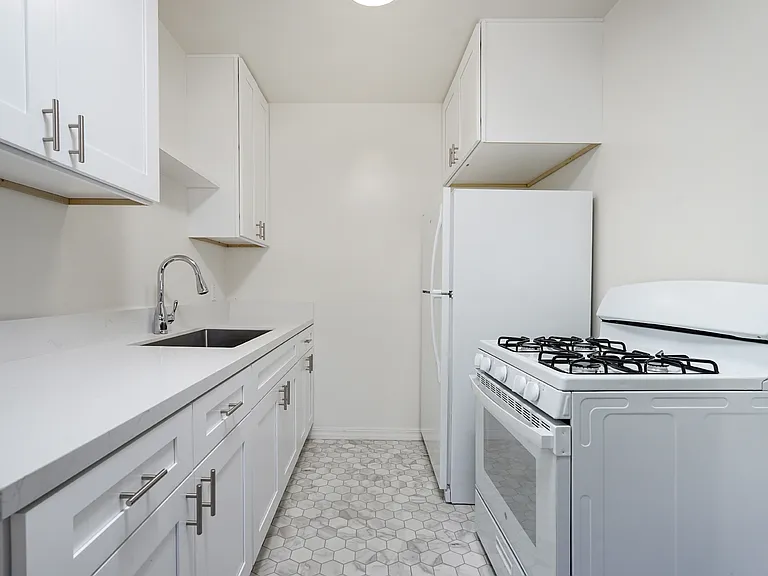 Remodeled kitchen with quartz counters and new appliances