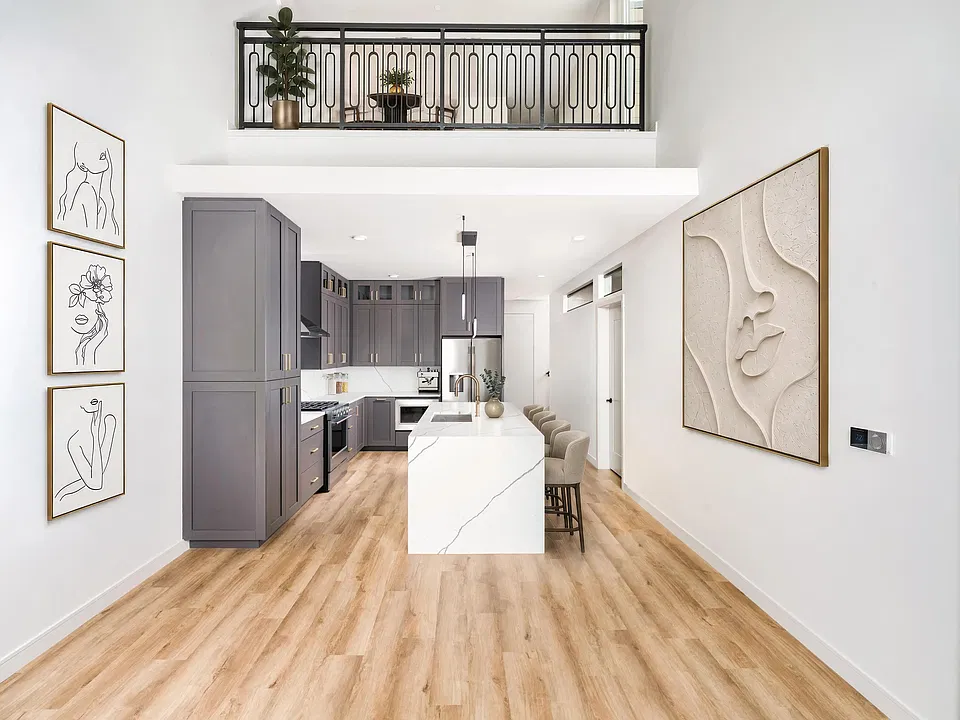 Select two-story floor plans feature lofted living spaces, quartz waterfall islands, contemporary cabinetry, and open-concept layouts designed for flexible living and entertaining.