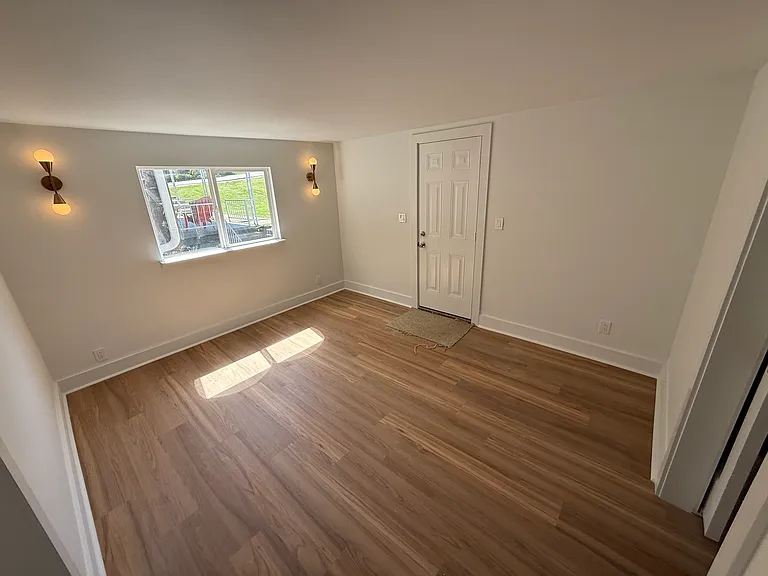 Bedroom 3 with large window and curtain rod has been installed since picture was taken. Door to back porch