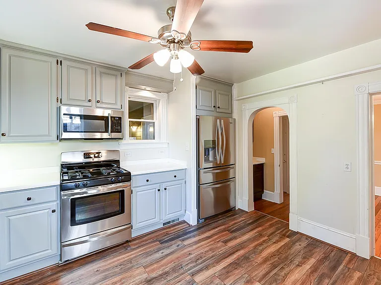 Kitchen looking toward front of house, door on right goes into dinning room, left doorway goes to extra cabinets and hall to front door.