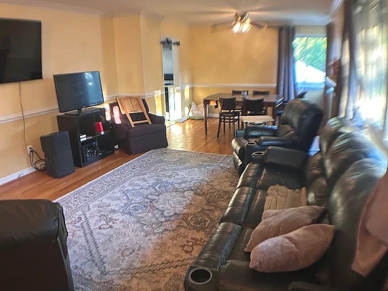Upstairs living room with dining area, showing larger seating capacity with full sized table.