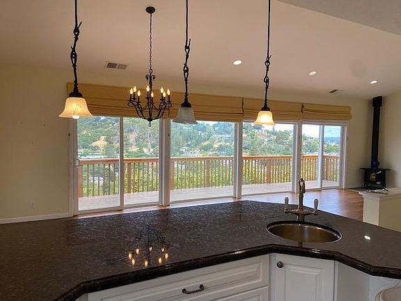 Gourmet kitchen with dishwasher, gas stove, oven, convection microwave, prep sink on peninsula, double sink, incredible storage with pull out shelves and/or rotating storage in every lower cabinet. Take in the views while entertaining!
