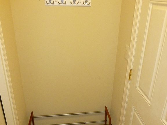 entryway has a shoe rack and hooks for your belongins