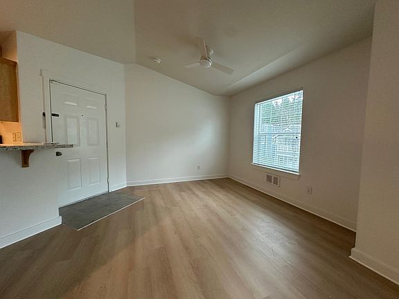 Front door and dining area with vaulted ceilings