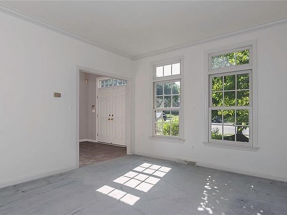 LIVING ROOM/DEN LOCATED TO LEFT OF THE FOYER.  SO LIGHT AND BRIGHT!