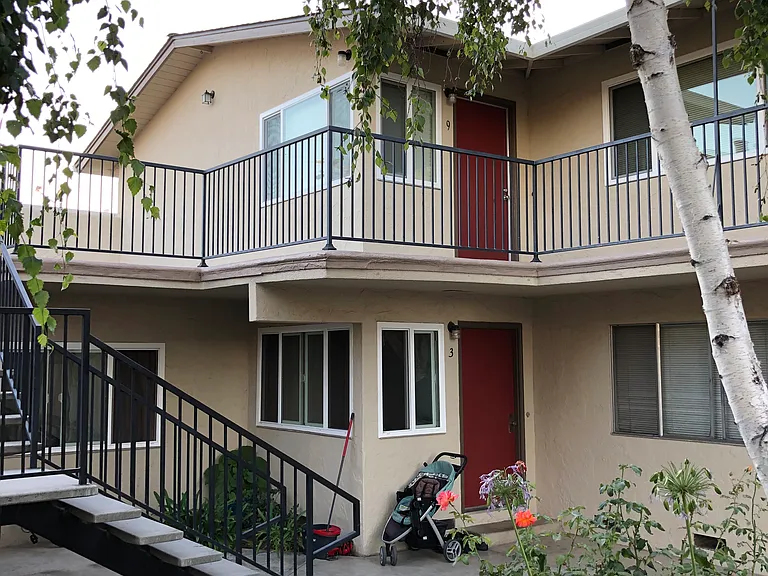 The upper apartments have stairways in the front and back by the laundry room.