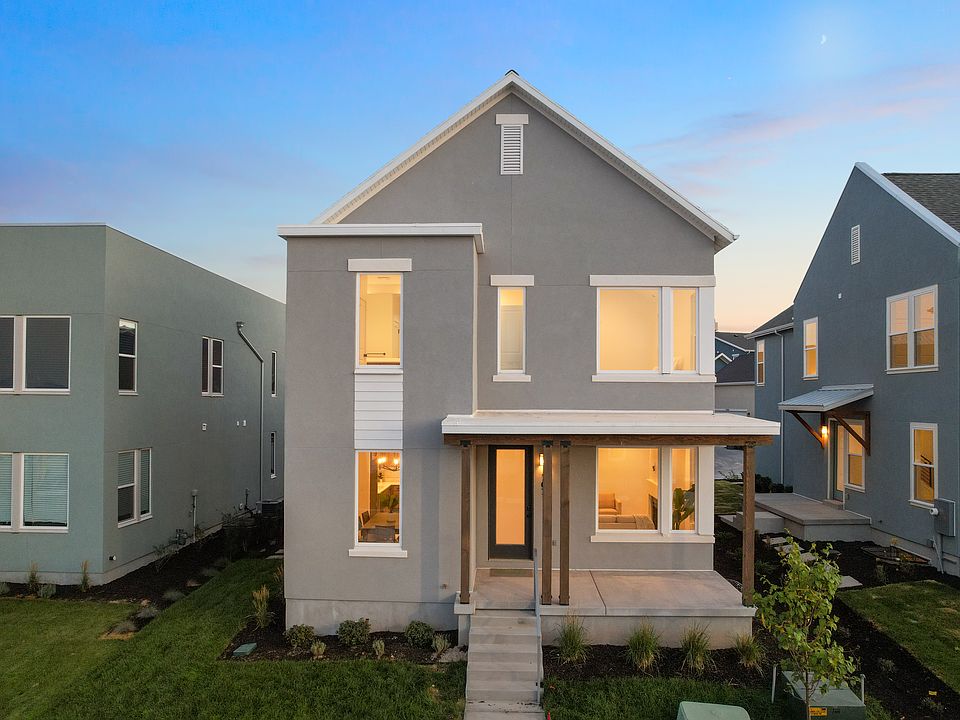 Modern two-story gray house from the Contempo Collection with large windows, a small front porch, an
