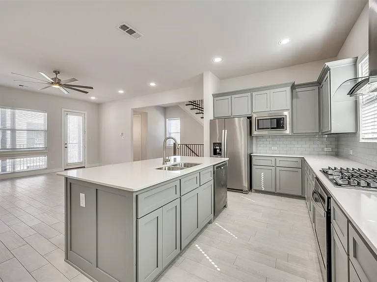 Large Open Kitchen includes a fridge, gas cooktop, oven and dishwasher.