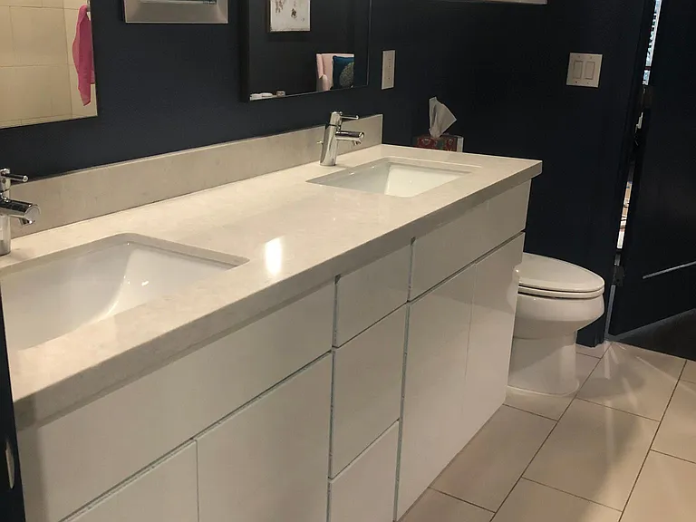 One bathroom with 2 sinks and a walk-in shower. No bathtub.
