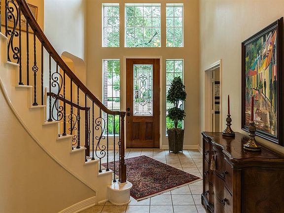 Elegant two story foyer with wall if windows.