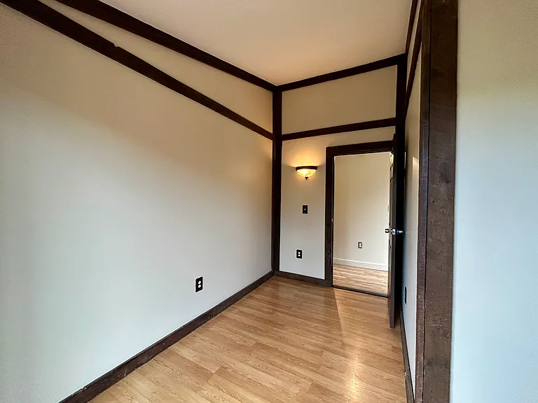 Sunny guest room or office with cozy nook and 7 ft. windows.