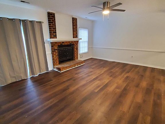 living room with operational wood burning fireplace