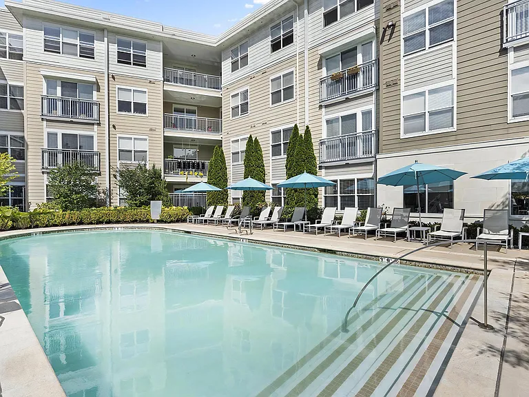 Community Pool with Poolside Umbrellas & Chairs