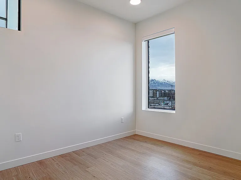 A spacious primary bedroom with abundant natural light.