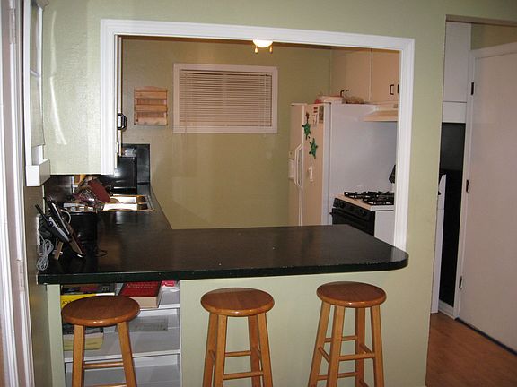 Kitchen open to dining with lots of sunlight