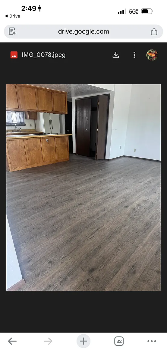 Open kitchen, dining area, living room, and washer & dryer closet. - 910 E Pueblo Dr